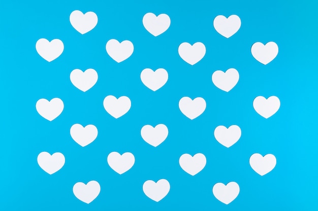 Group of white hearts on blue background