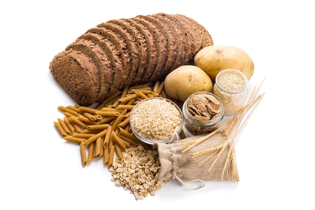 Group of whole foods complex carbohydrates isolated on a white background