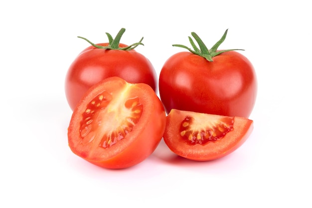 Group of whole and sliced tomatoes isolated on a white background in closeup