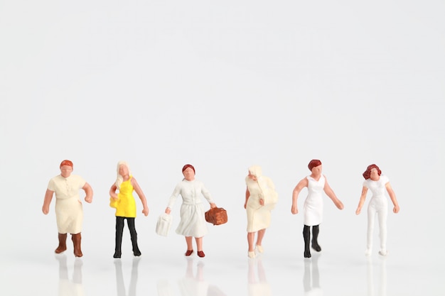 a group of woman walking on white 