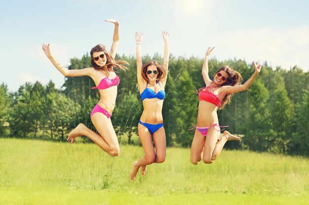 a group of women in bikin having fun outdoors