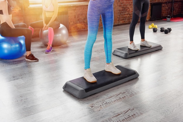 Group of women do exercises at the gym