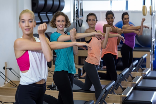 group of women exercising on reformer