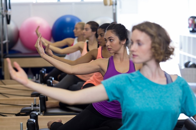 group of women exercising on reformer