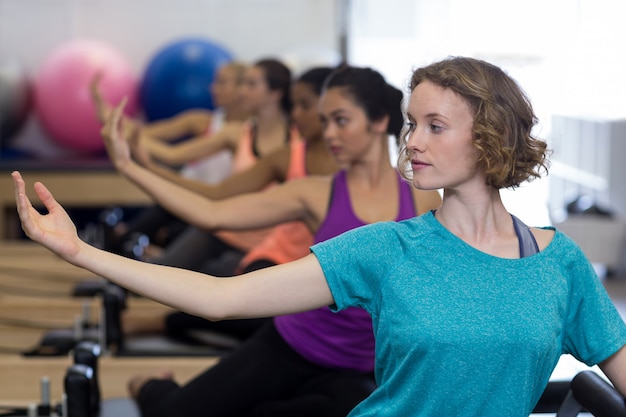 group of women exercising on reformer