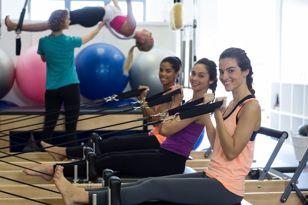 group of women exercising on reformer