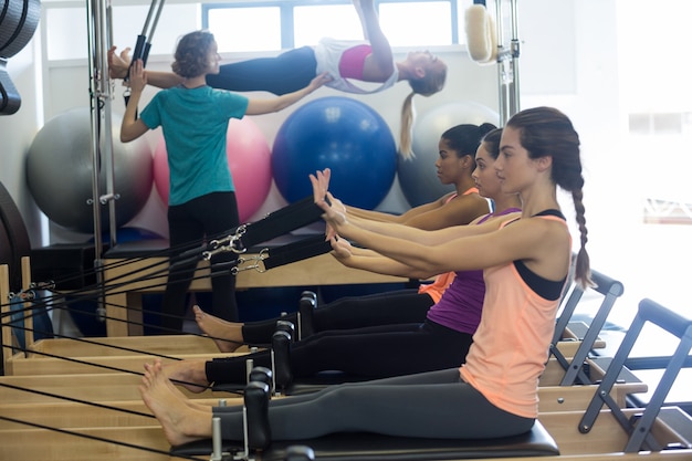 Group of women exercising on reformer