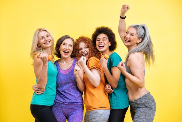 Group of women with different body, age, and ethnicity making sport. Female models wearing sport outfits having fun at the gym. Concept about body positivity, self acceptance and lifestyle