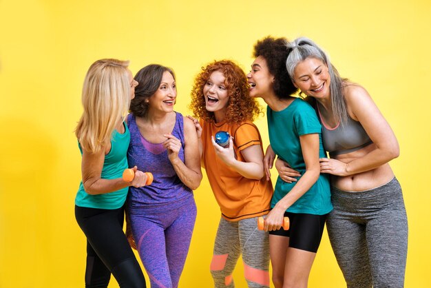 Group of women with different body, age, and ethnicity making sport. Female models wearing sport outfits having fun at the gym. Concept about body positivity, self acceptance and lifestyle