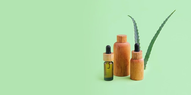 Group of wooden cosmetics tubes with aloe vera on background Organic cosmetic concept
