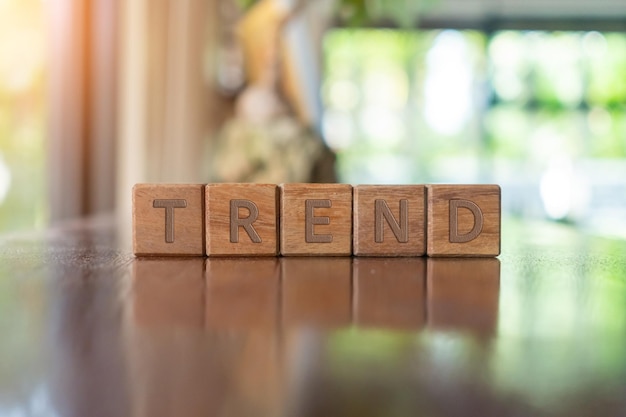 A group wooden cubes on table with word Trend on it