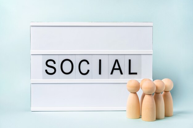 A group of wooden people and the words "Social"