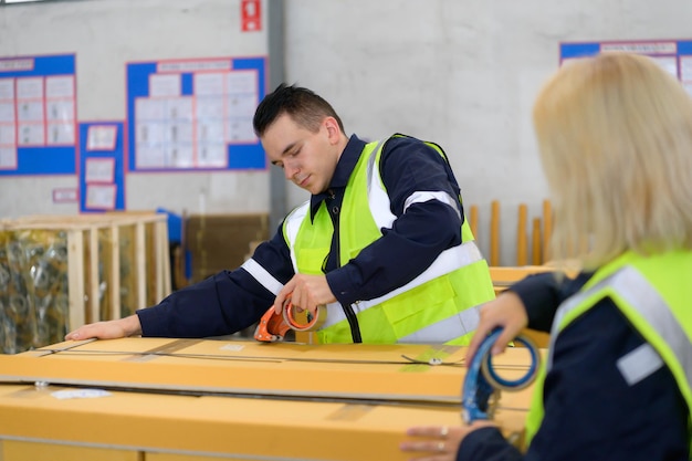 Group of worker in auto parts warehouse Packing small parts in boxes after inspecting the car parts