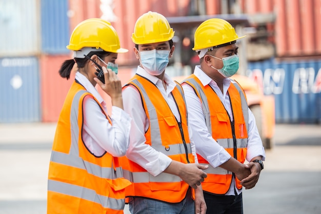 Group of workers in container warehouse