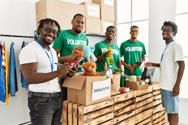 Photo group of young african american volunteers working at charity center.