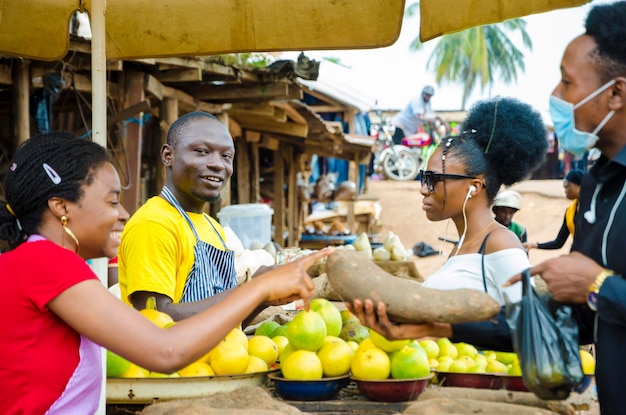 group of young africans making transaction happening in a market place.