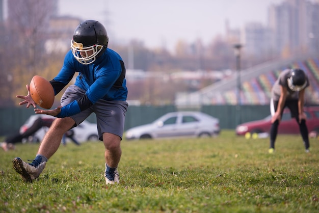 group of young american football players in action during the training at field