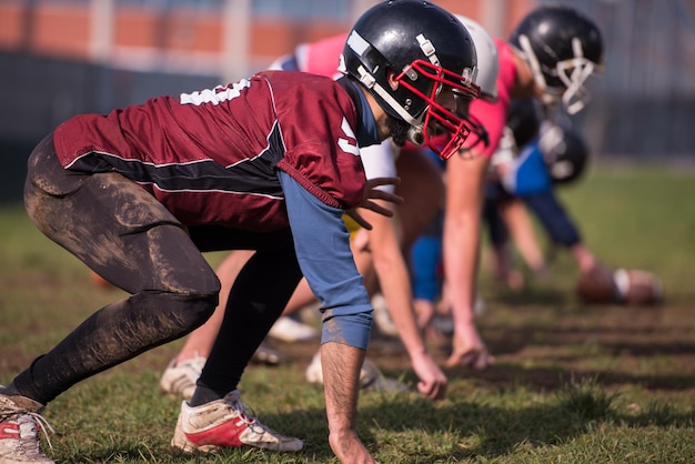 group of young american football players in action during the training at field