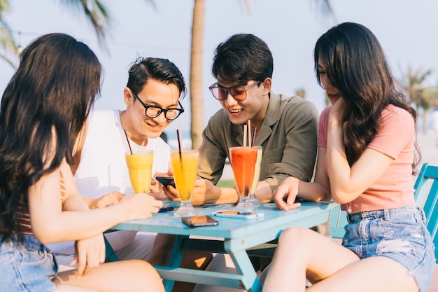 A group of young Asians enjoy a trip to the sea on a summer vacation