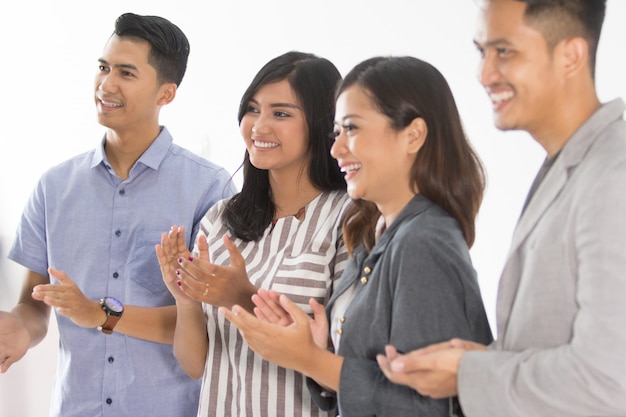 Group of young business people applause