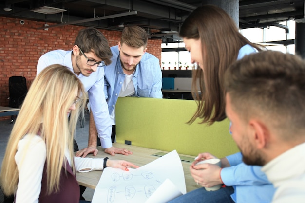 Group of young business people and designers in smart casual wear. They working on new project.