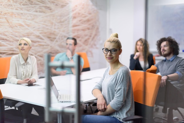 Group of a young business people discussing business plan at modern startup late night office building