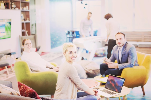 Group of a young business people discussing business plan at modern startup office building