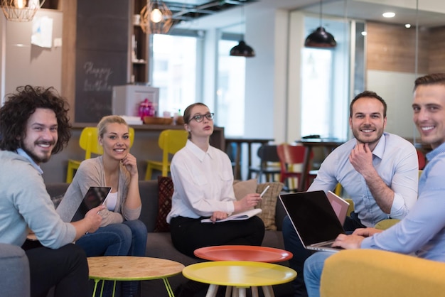 Group of a young business people discussing business plan at modern startup office building