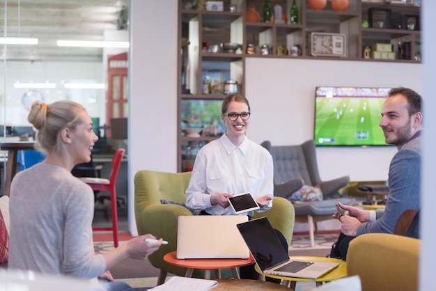 Group of a young business people discussing business plan at modern startup office building