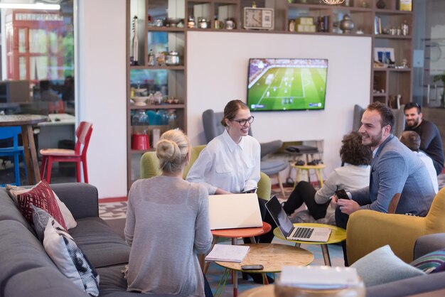 Group of a young business people discussing business plan at modern startup office building