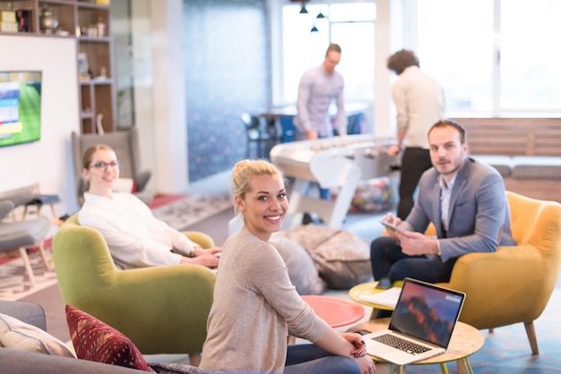 Group of a young business people discussing business plan at modern startup office building