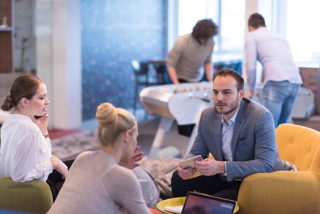 Group of a young business people discussing business plan at modern startup office building