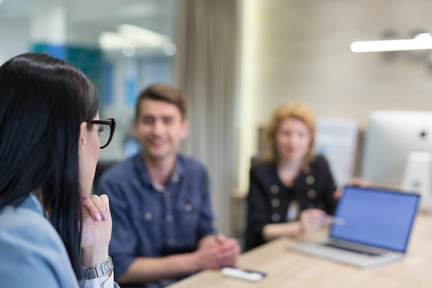 Group of a young business people discussing business plan at modern startup office building