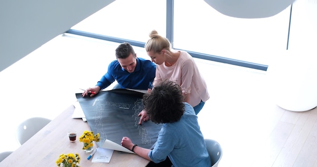 Photo group of a young business people discussing business plan at modern startup office building