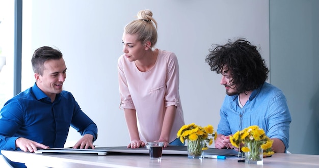 Group of a young business people discussing business plan at modern startup office building