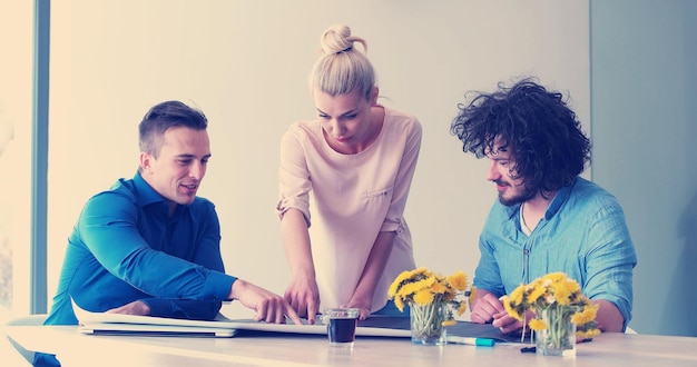 Photo group of a young business people discussing business plan at modern startup office building