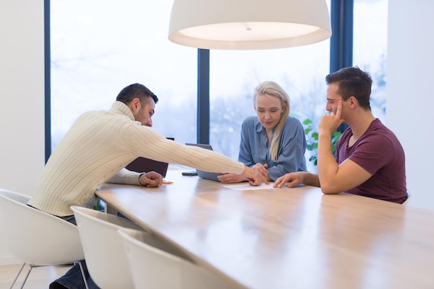 Group of a young business people discussing business plan at modern startup office building