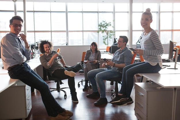 Group of a young business people discussing business plan  in the office