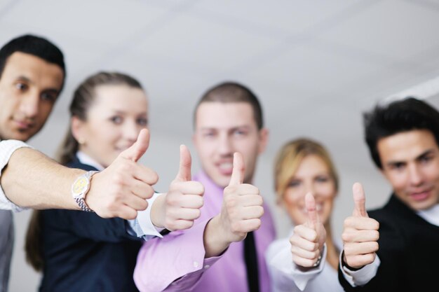 Group of young business people sitting in board room during meeting and discussing with paperwork