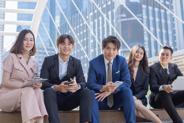 Group of young business people smiling and looking at camera with success concept