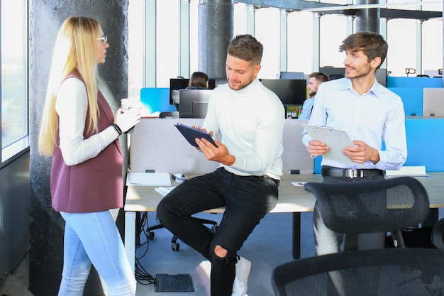 Group of young business people working and communicating together in creative office