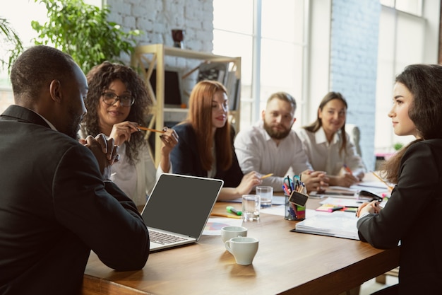 Group of young business professionals having a meeting, creative office