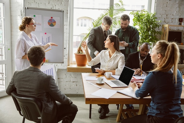 Group of young business professionals having a meeting creative office