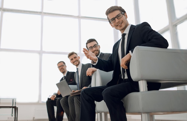 Group of young businessmen sitting in the lobby of the business centerphoto with copy space