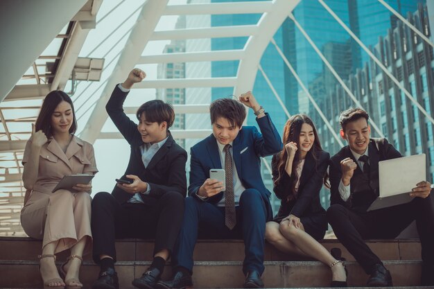 Group of young businesspeople smiling and looking at camera