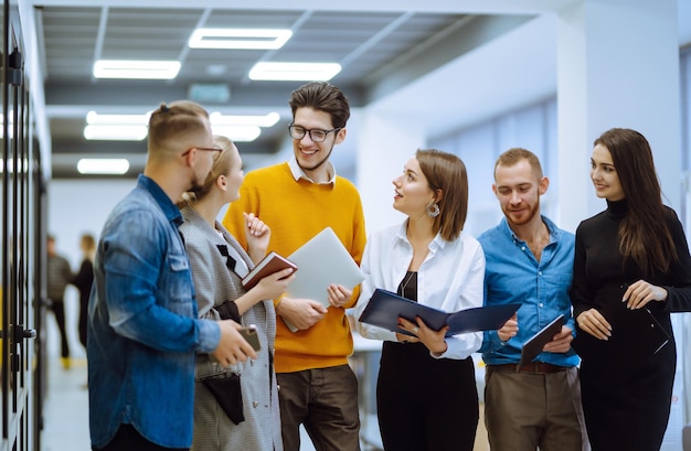 Group of young businesspeople working together in creative office