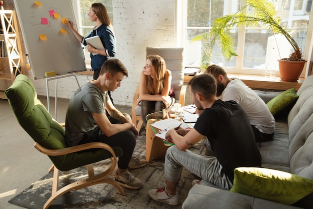 Group of young caucasian office workers meeting to discuss new ideas Creative meeting