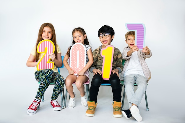 A group of young children holding a 2017 cutours