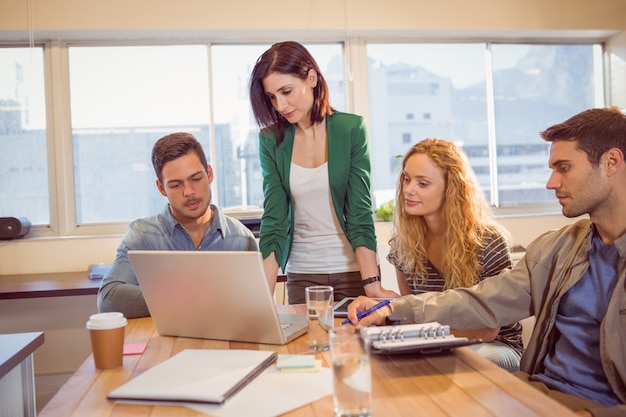 Group of young colleagues using laptop