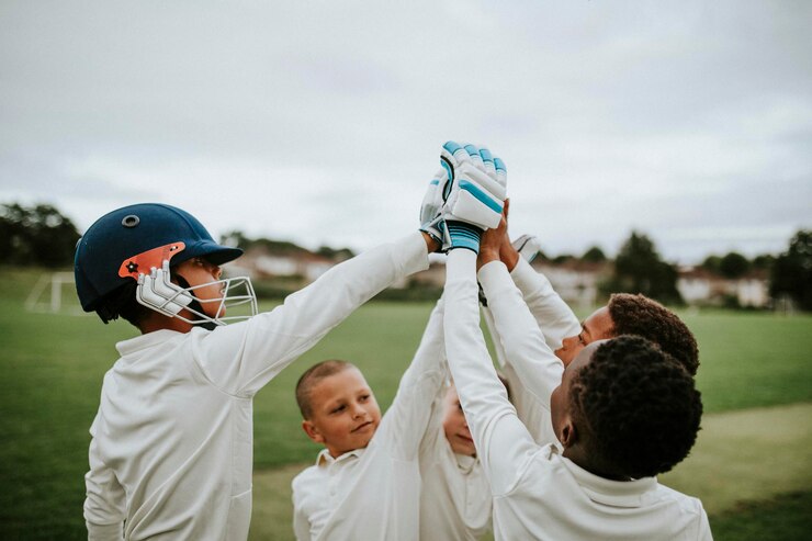 Group of young cricketers doing a high five